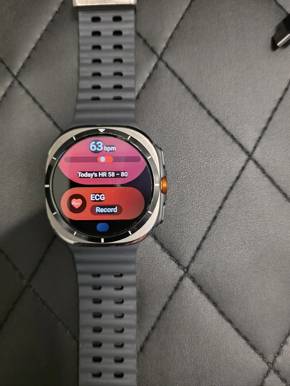 Samsung Gray Smartwatch with Orange Accent and Dark Gray Band
